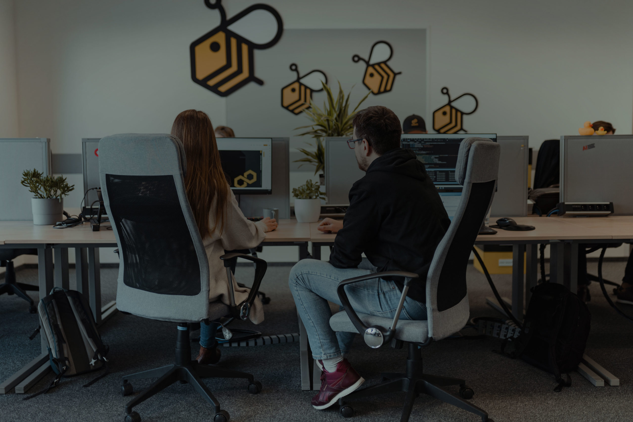 A man and a woman working together on a presentation in A4BEE office