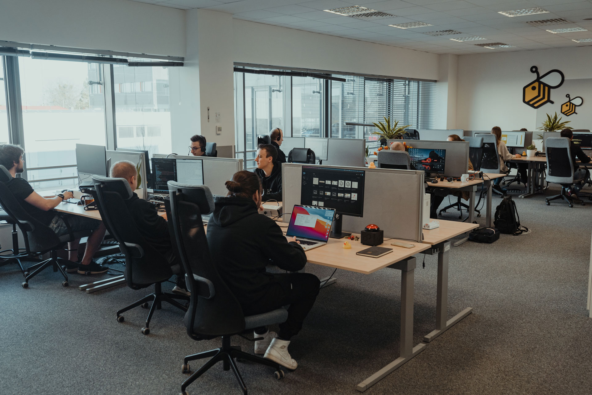 A closer shot of the open space in the A4BEE office, with multiple people working