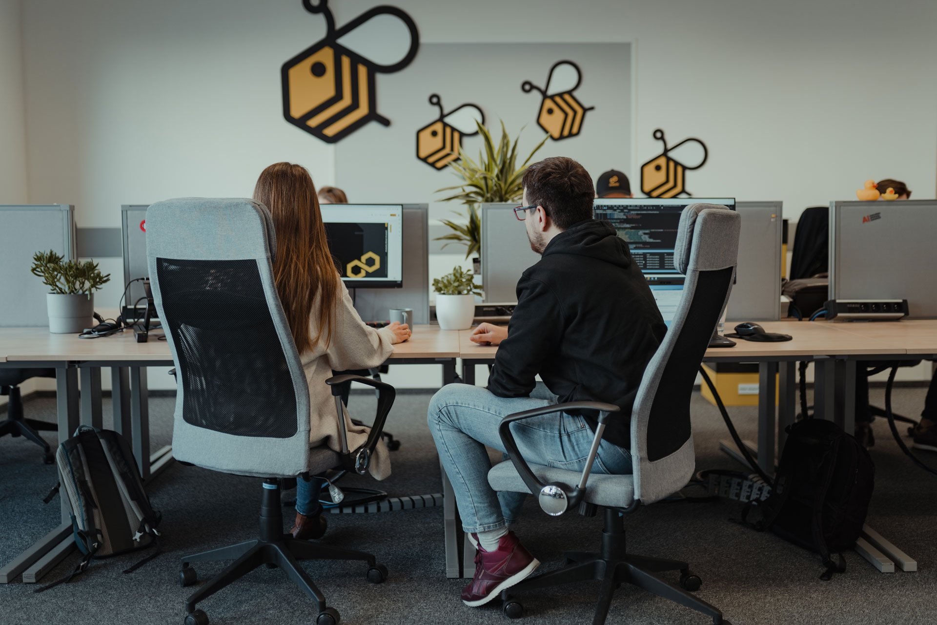 A man and a woman working together on a presentation in A4BEE office