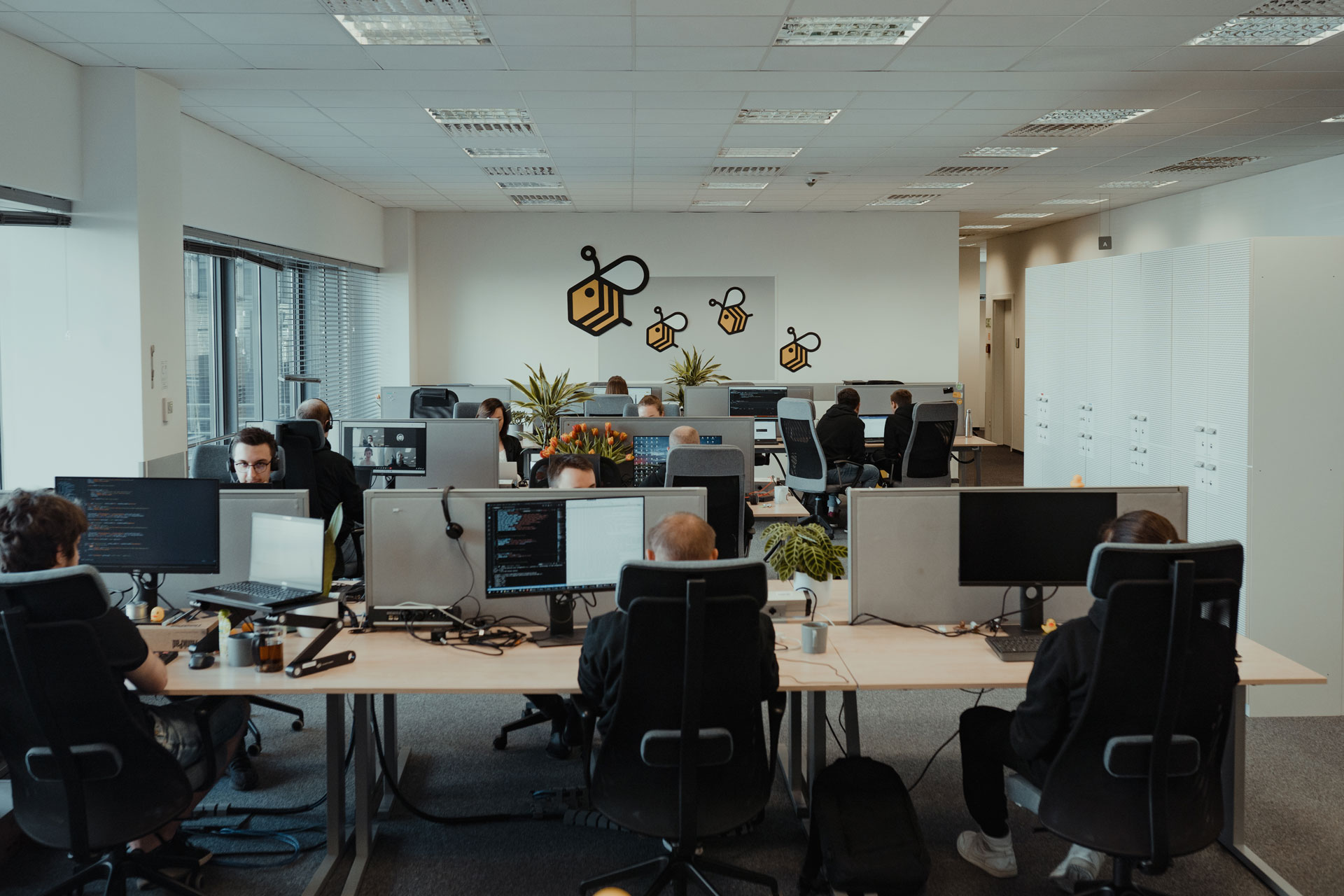 Wide shot of A4BEE open space office with people working