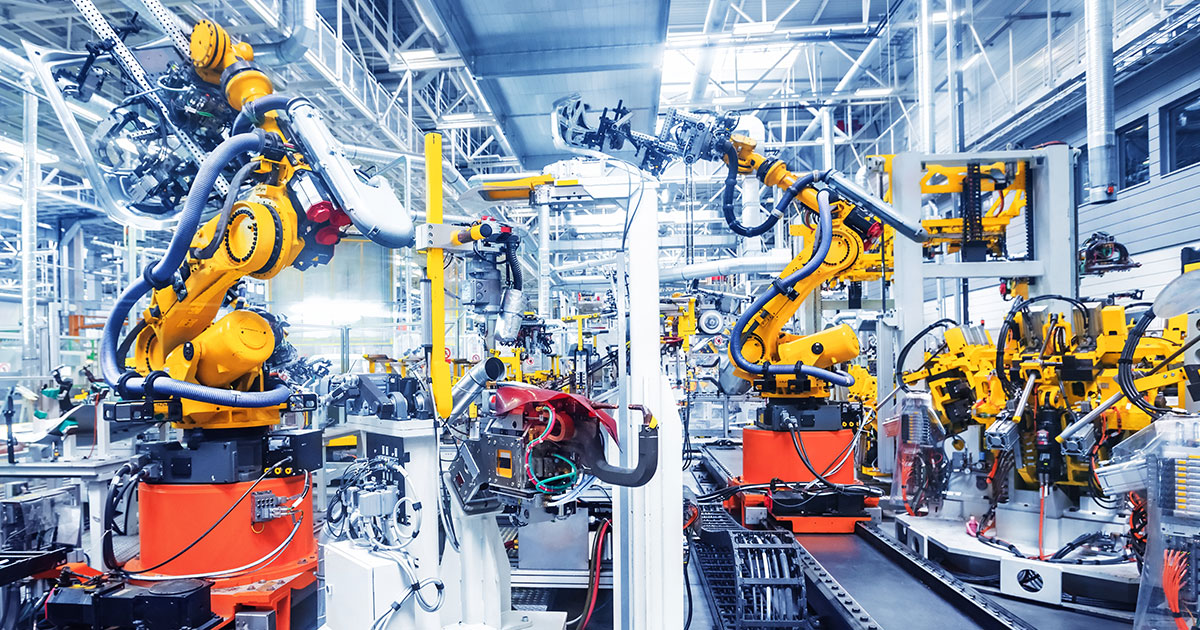 A factory with multiple robot arms on the production assembly line